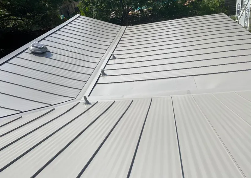Solar attic fan installed on a metal roof for Roof Ventilation in Terre Haute